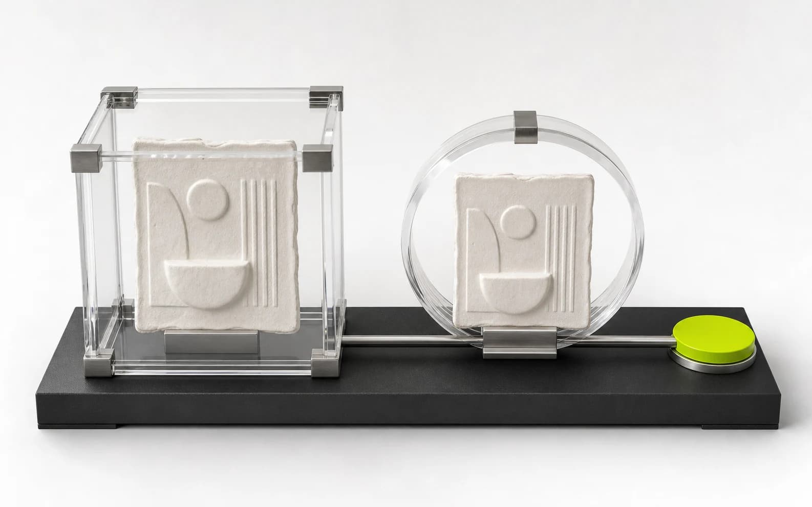 Two identical handmade ceramic relief tiles sit inside a clear archival case and on a rail passing through a clear meter toward a lime payout disc.